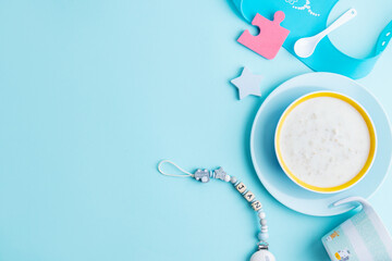 Obraz na płótnie Canvas Baby plate with porridge on blue