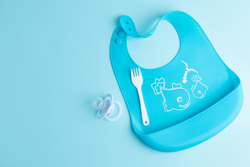 Baby plate with porridge on blue
