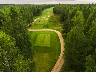 Aerial view of golf course fairway and green. Top view of beautiful green golf course