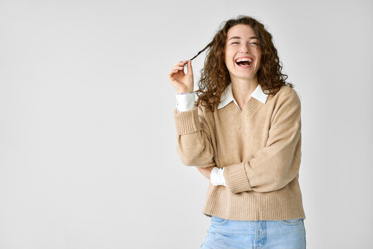 Young Adult Smiling Beautiful Positive Woman Model, Joyful Pretty Cheerful Cute Curly Girl Student Looking At Camera Laughing Playing With Curly Hair, Standing Isolated At White Background, Portrait.