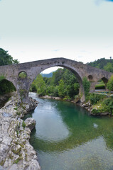 Fototapeta na wymiar The Roman bridge of Cangas de Onis, in Asturias, Spain, below, the river Sella.