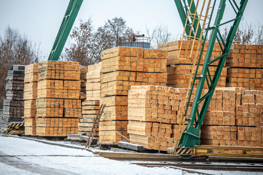 Wood factory stock and lumber board with nature business export. Stack of new wooden planks. Close up. Wooden planks for construction are sold in market. Stack of lumber wood in timber log storage