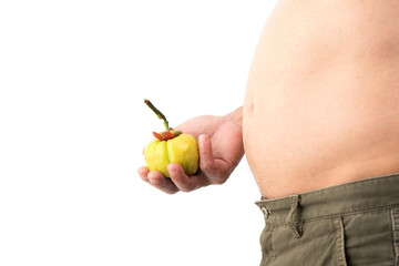 Obese man standing holding garcinia cambogia and has medicinal properties that can help you lose...