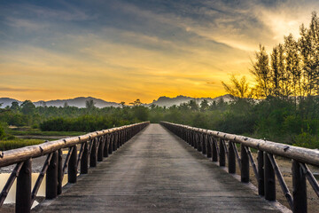 Fototapeta na wymiar wooden bridge over river sunrise