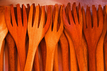 Top down view of wooden forks on display.