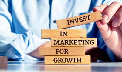 Close up on businessman holding a wooden block with an 