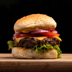 Fresh tasty hamburger on dark background with drink cheeseburger front