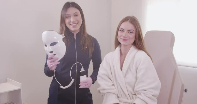 aesthetic professional Using led mask on patient for aesthetic treatment, relaxation, rejuvenation, color therapy, light therapy, skin care.