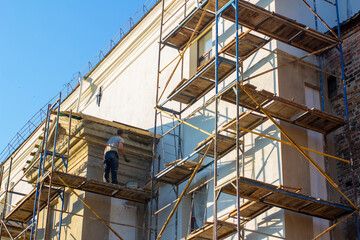 Builder on the scaffolding works on the restoration of the monastery in the Baroque style