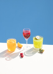 Juice drink cocktails on a cream blue background. Visual aesthetic Summer concept.