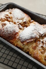 Fototapeta na wymiar Delicious yeast dough cake in baking pan on table, closeup