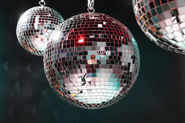 Bright shiny disco balls on dark background