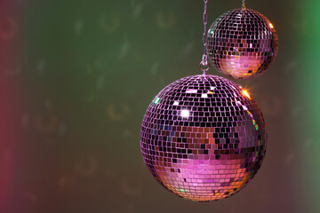 Shiny disco balls on color background, space for text