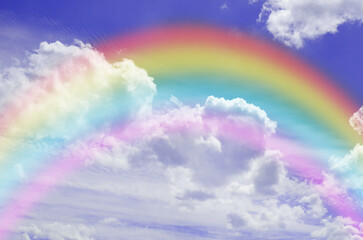 Beautiful sky with bright rainbow and fluffy clouds