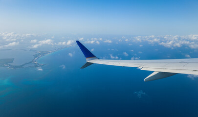 aerial view from a window seat captures the majestic airplane wing soaring through the clouds, symbolizing freedom, adventure, and travel. The view offers a sense of perspective