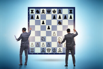 Business people playing chess on the board