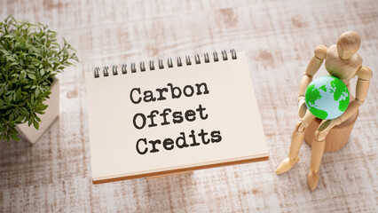 There is notebook with the word Carbon Offset Credits.It is as an eye-catching image.