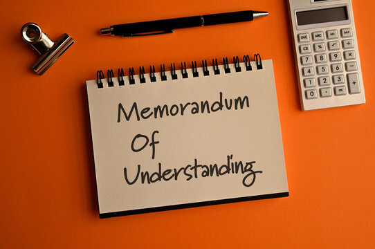 There is notebook with the word Memorandum of Understanding.It is as an eye-catching image.