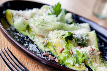 Zucchini salad with parmesan cheese and pine nuts