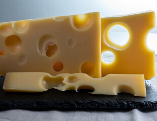 Swiss cheese collection, yellow emmentaler or emmental cheese with round holes