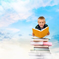 Back to school concept, Happy child on tower of books