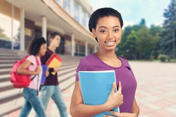 Pretty young woman university student with books