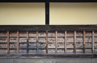 Mud wall of a Japanese house. Traditional Japanese-style fence made of clay and wood.