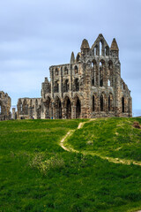England, North Yorkshire, Whitby. North Sea, East cliff. English Heritage site, ruins of Benedictine abbey, Whitby Abbey, monastery. Inspiration for  Bram Stoker's gothic tale Dracula.