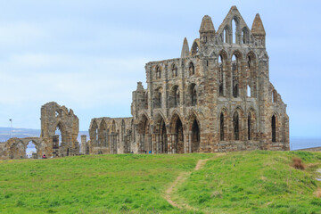 Fototapeta na wymiar England, North Yorkshire, Whitby. North Sea, East cliff. English Heritage site, ruins of Benedictine abbey, Whitby Abbey, monastery. Inspiration for Bram Stoker's gothic tale Dracula.