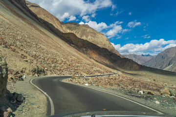 road with two sides are high mountains, and blue sky. Beautiful scenery on the way to Turturk Villgae, Leh, Ladakh, Jammu and Kashmir, India