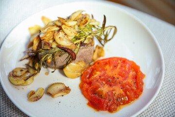 A mouth-watering steak dinner with tomato and garlic represents a balance of indulgence and healthy nourishment. Symbolizing strength, vitality, and a celebration of life