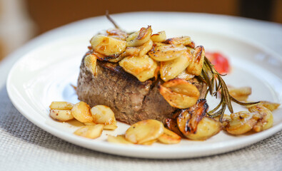 A mouth-watering steak dinner with tomato and garlic represents a balance of indulgence and healthy nourishment. Symbolizing strength, vitality, and a celebration of life