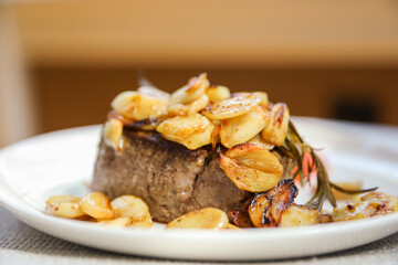 A mouth-watering steak dinner with tomato and garlic represents a balance of indulgence and healthy nourishment. Symbolizing strength, vitality, and a celebration of life