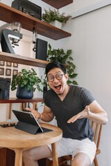 Wow and surprise face of freelance asian man working in the cafe.