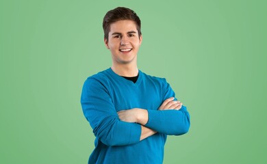 Young smiling man posing on background