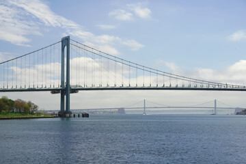 Fototapeta na wymiar Whitestone Bridge and Throggs Neck Bridge connecting the Bronx and Queens boroughs, ocean view from Ferry Point Park Soundview NYC Ferry line