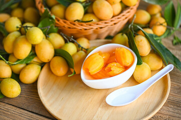 tropical fruit Name in Thailand sweet Yellow Marian Plum Maprang Plango or Mayong chid, Sweet dessert marian plum fruit  on bowl for food and wooden background