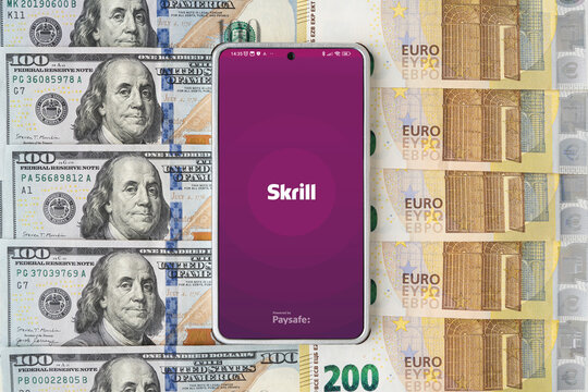 skrill application on smartphone on dollars and euros bills