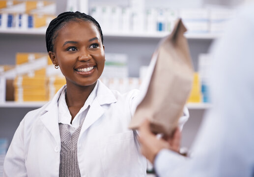 Black woman, medicine or pharmacist hands customer a bag in drugstore with healthcare prescription receipt. Shopping or happy African doctor giving patient pills or package in medical retail service