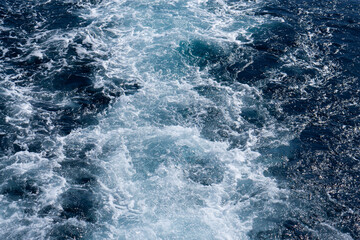 Fototapeta na wymiar Background shot of aqua sea water surface. Red sea. Blue ocean water texture background. Surface of the sea.