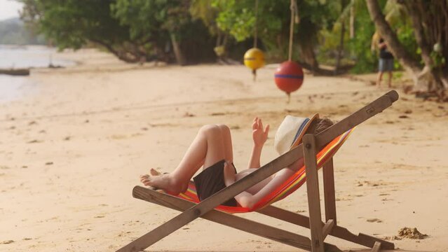 Boy Lying Down On The Sun Lounger
