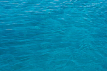 Background shot of aqua sea water surface. Red sea. Blue ocean water texture background. Surface of the sea.