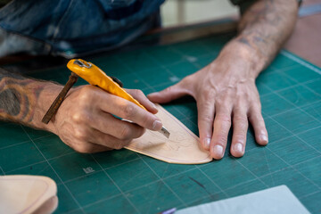 Young man working on animal skins at workshop