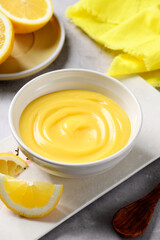 Homemade vanilla custard pudding or lemon curd in a white bowl.
