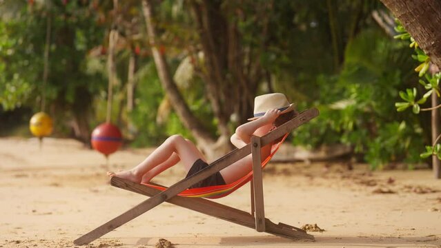 Boy Lying On Sun Lounger Resting