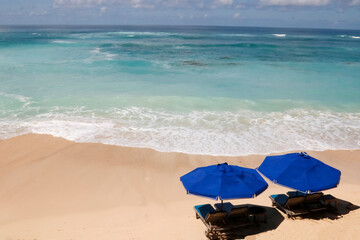 Beach chairs on the white sand beach 