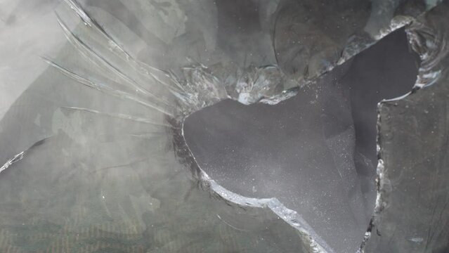 close-up of the broken glass of the tv screen after hitting with a hammer.selective focus.cracks on the broken cracked glass of the kinescope tv