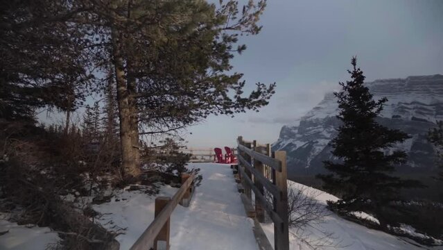 two red chairs at hoodoos viewpoint at banff with epic view on mountains