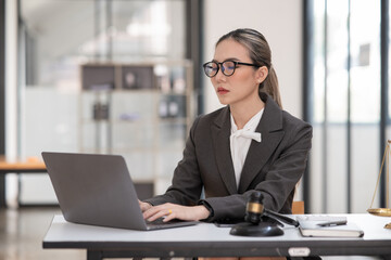 Lawyers Asiawoman   having through online Concepts  of Legal services at the law office.