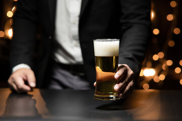 Businessman sitting and holding glass of whiskey